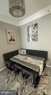 a view of a dinning room with a table and chairs