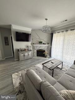 1581 Spring Gate Dr., Unit 5403 McLean, VA 22102 - Photo 6 of 16 a living room with furniture a flat screen tv and a fireplace
