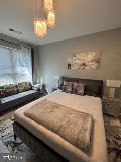 1581 Spring Gate Dr., Unit 5403 McLean, VA 22102 - Photo 8 of 16 a bedroom with a bed and chandelier