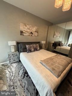 1581 Spring Gate Dr., Unit 5403 McLean, VA 22102 - Photo 9 of 16 a bedroom with a bed and a chandelier
