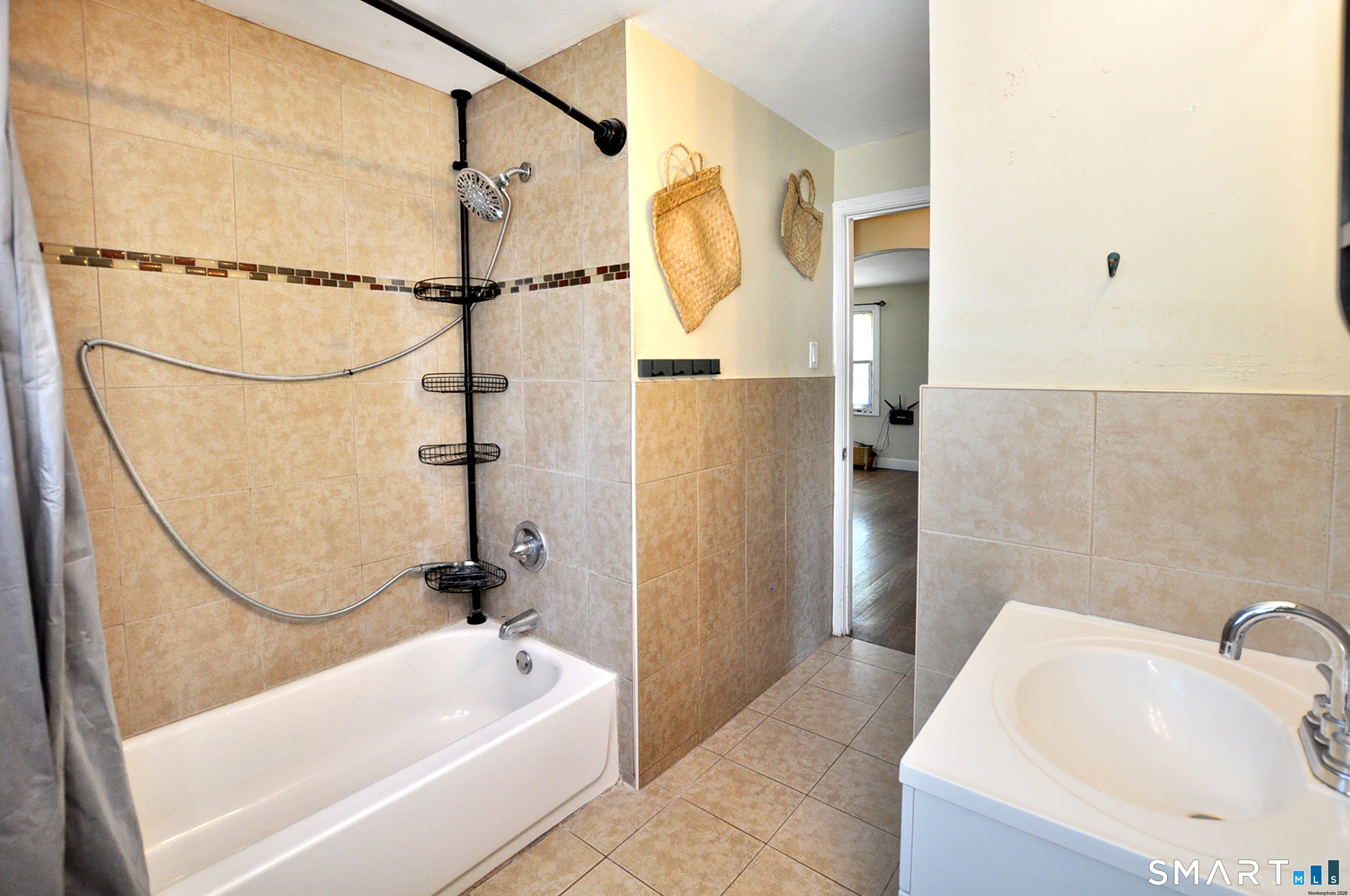 103 West Center Street Manchester, CT 06040 - Photo 20 of 29 a bathroom with a tub a sink and a shower