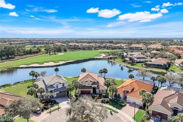 an aerial view of a house with a lake view