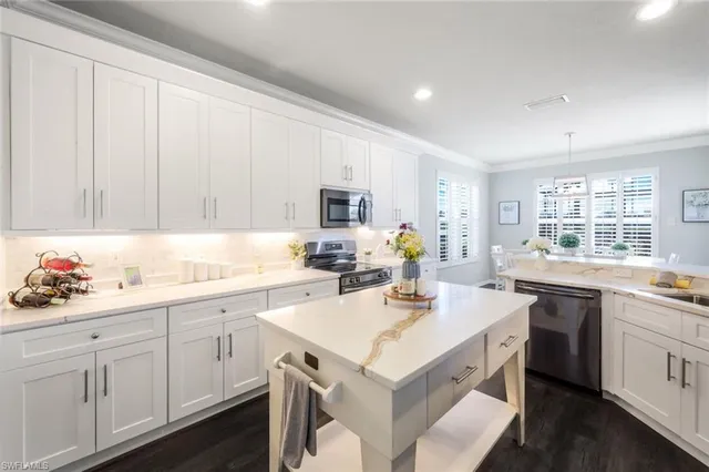 a kitchen with a sink stove and cabinets