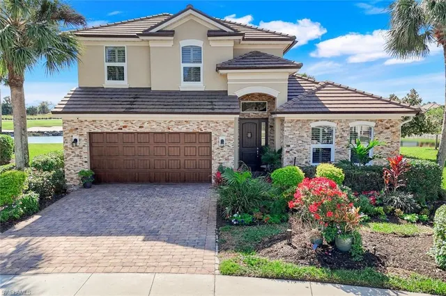 a front view of a house with a yard and a garage