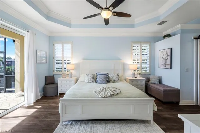 a bedroom with a large bed couch and a window