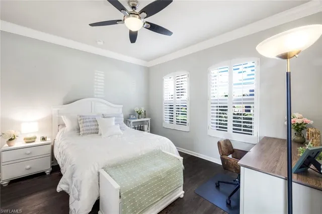 a bedroom with a bed and a desk