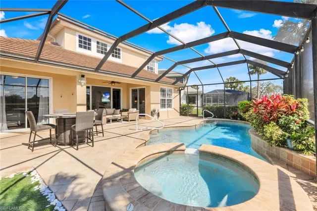 a view of a swimming pool with outdoor seating