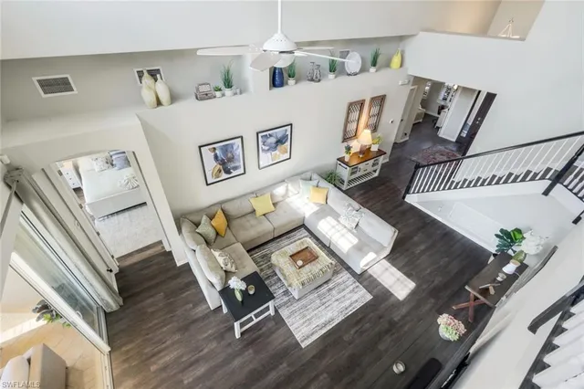 a living room with furniture and floor to ceiling windows