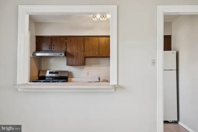 a kitchen with stainless steel appliances a sink and a refrigerator