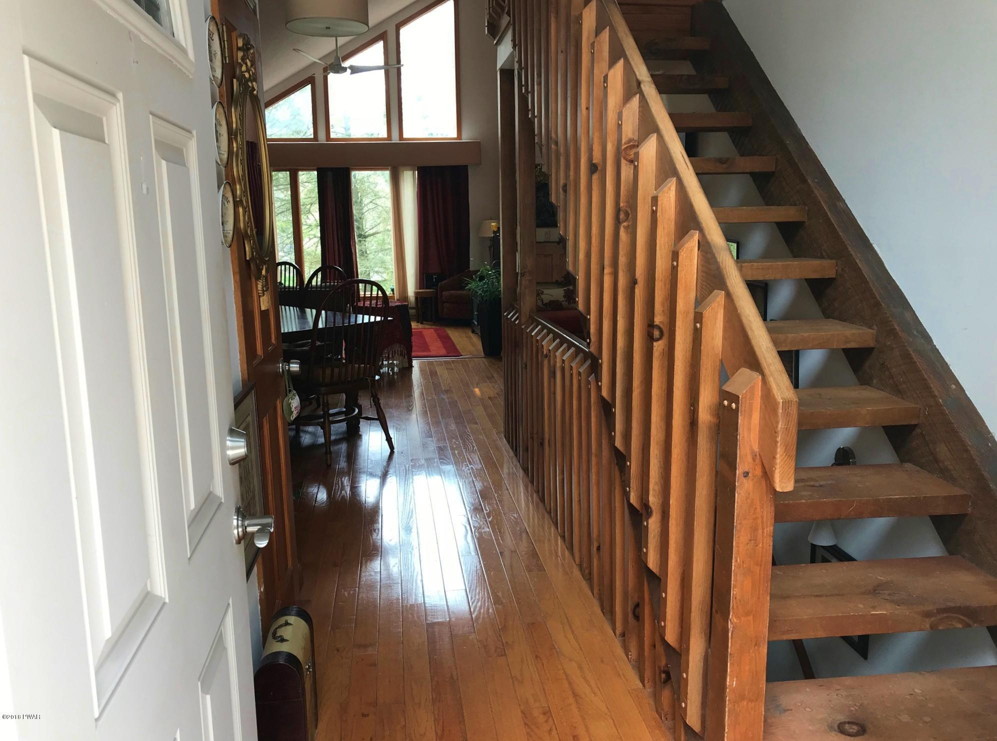 2335 Brookfield Road Lake Ariel, PA 18436 - Photo 3 of 42 a view of a hallway with wooden floor and staircase