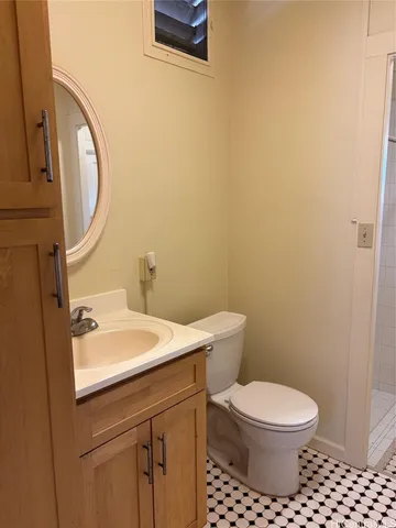 a bathroom with a toilet a sink and a mirror