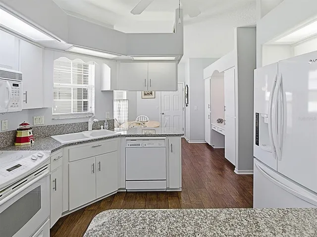 a kitchen with a refrigerator and a sink