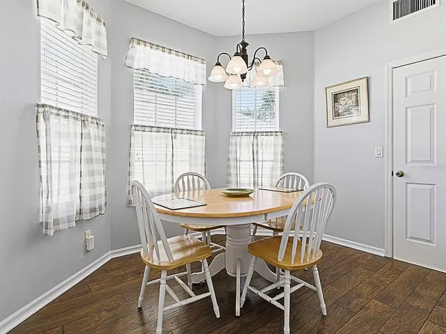 a view of a dining room with furniture window and wooden floor