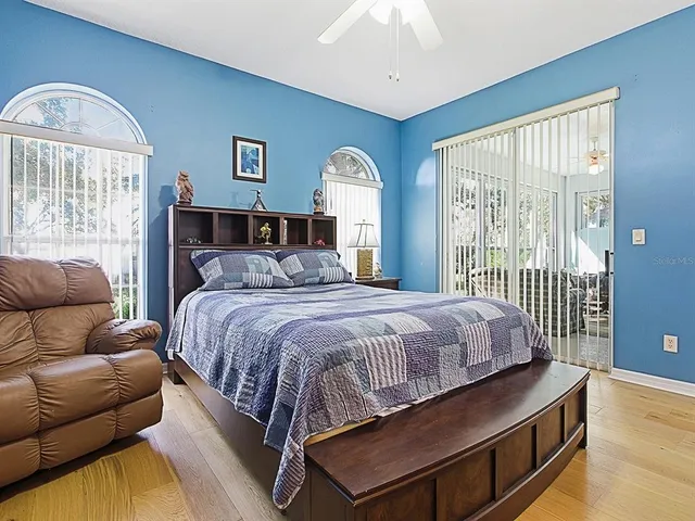 a bedroom with a large bed and a large window