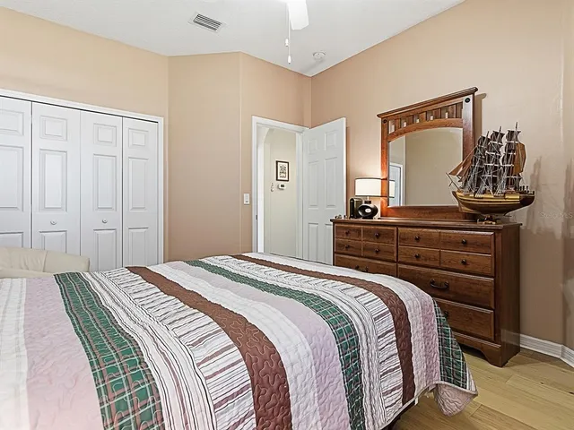 a bedroom with a bed and a dresser