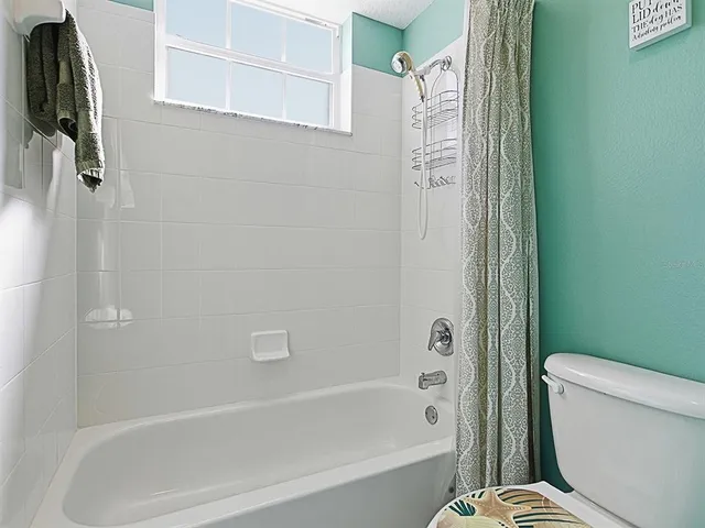 a bathroom with a toilet and a bathtub