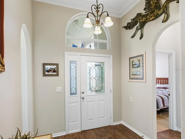 a view of a hallway with windows and entryway