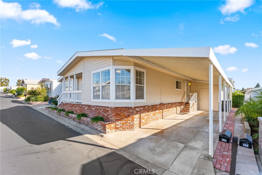 23301 Ridge Rte Drive, Unit 165 Laguna Hills, CA 92653 - Photo 1 of 31 a front view of a house with basket ball court and potted plants