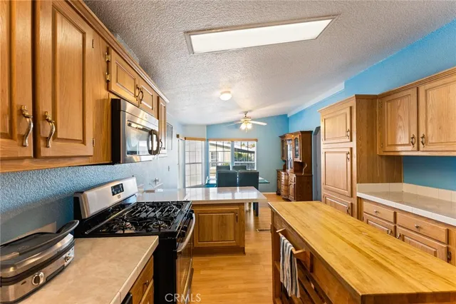 a kitchen with stainless steel appliances granite countertop a stove and a sink