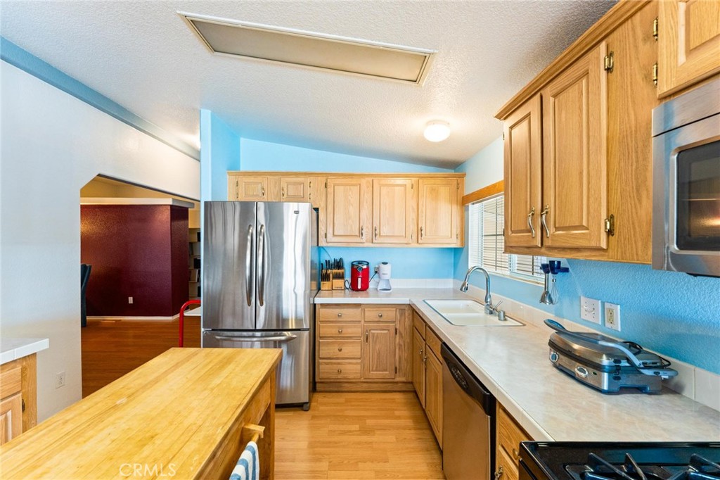 23301 Ridge Rte Drive, Unit 165 Laguna Hills, CA 92653 - Photo 14 of 31 a kitchen that has a sink and a stove in it