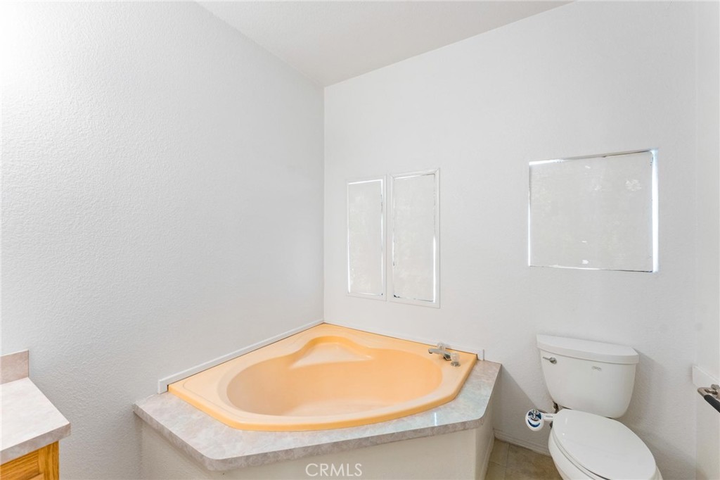 23301 Ridge Rte Drive, Unit 165 Laguna Hills, CA 92653 - Photo 21 of 31 a bathroom with a toilet and a sink