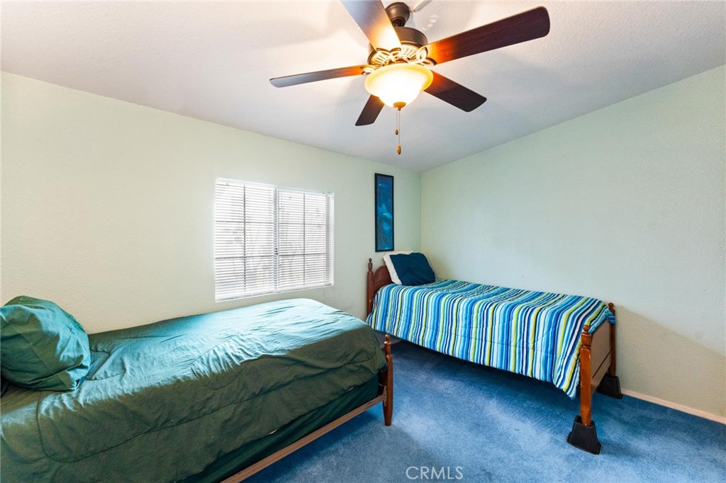 23301 Ridge Rte Drive, Unit 165 Laguna Hills, CA 92653 - Photo 22 of 31 a bedroom with a bed and a window