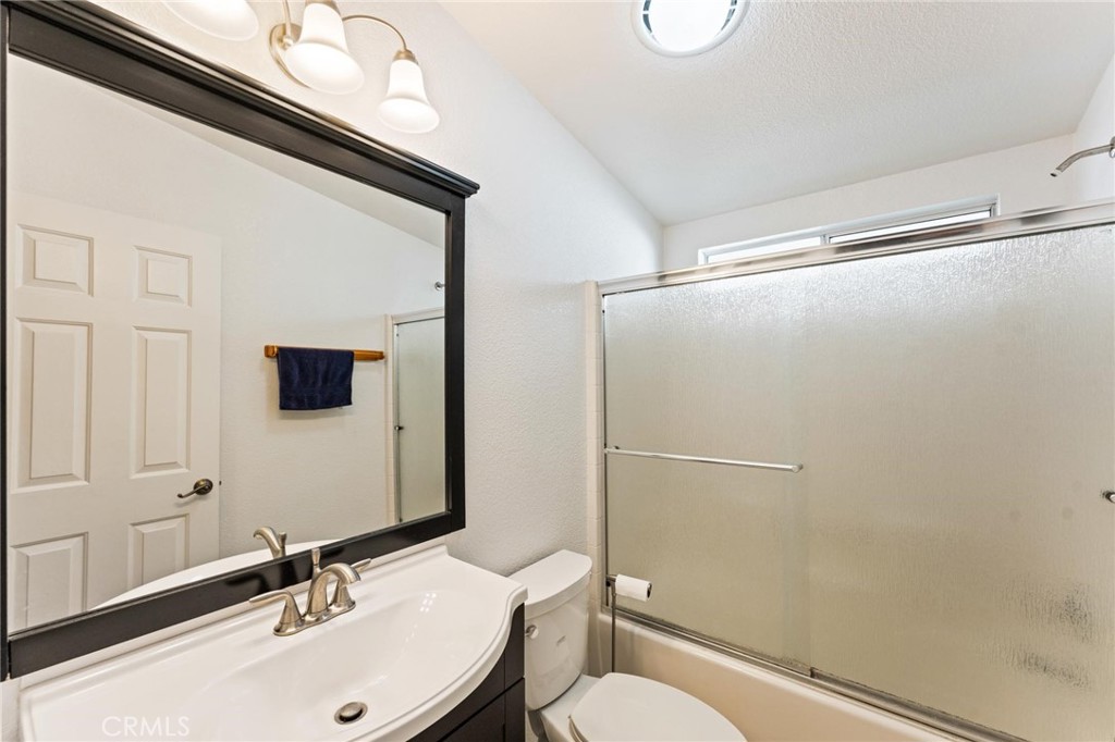 23301 Ridge Rte Drive, Unit 165 Laguna Hills, CA 92653 - Photo 24 of 31 a bathroom with a sink mirror vanity and toilet