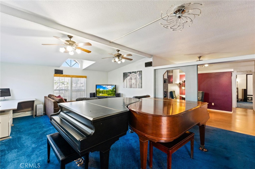 23301 Ridge Rte Drive, Unit 165 Laguna Hills, CA 92653 - Photo 3 of 31 a living room with fireplace furniture and a wooden floor