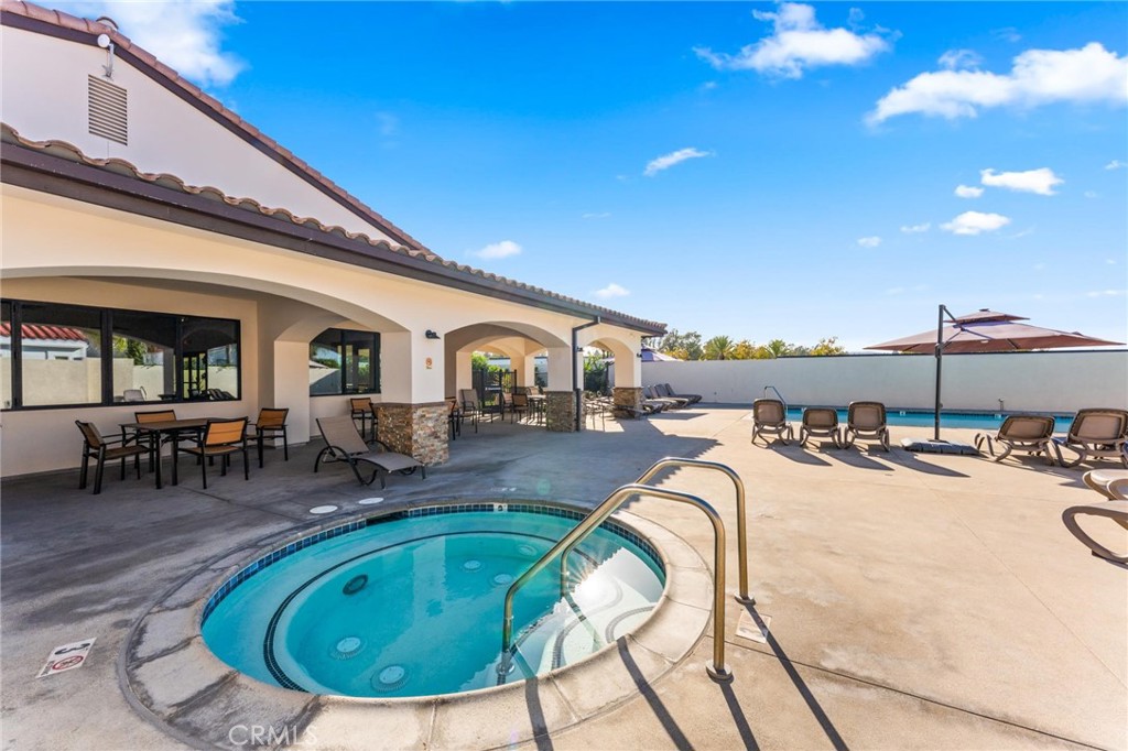 23301 Ridge Rte Drive, Unit 165 Laguna Hills, CA 92653 - Photo 31 of 31 a view of a swimming pool with outdoor seating
