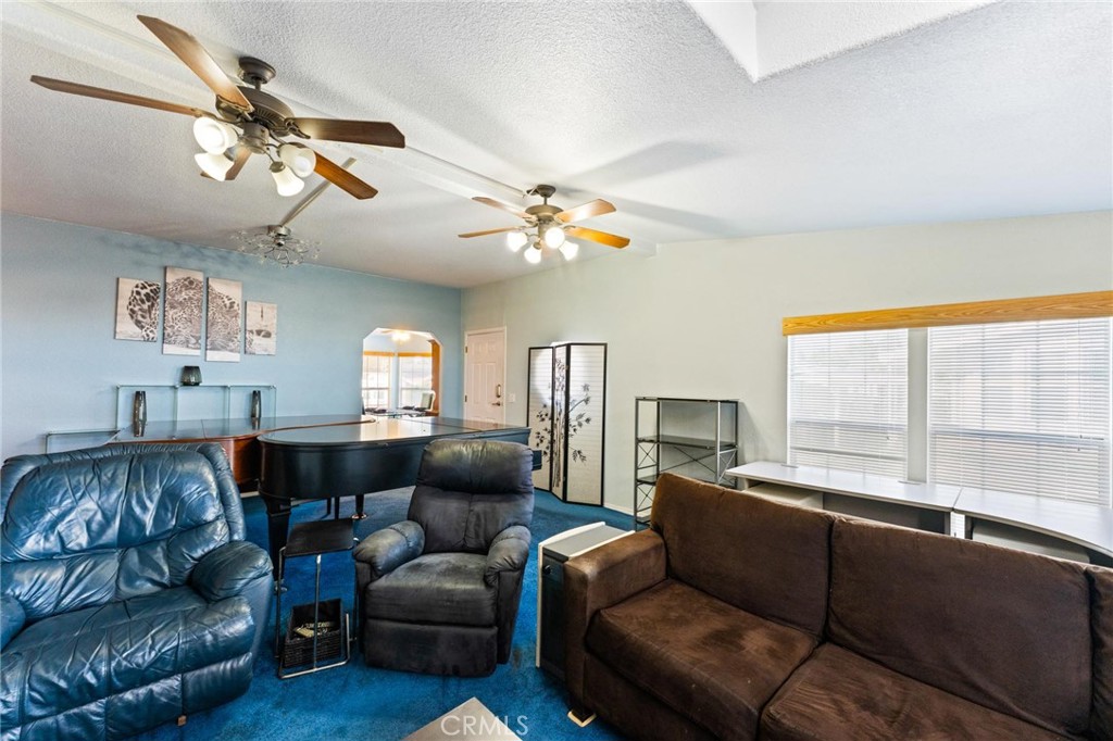 23301 Ridge Rte Drive, Unit 165 Laguna Hills, CA 92653 - Photo 5 of 31 a living room with furniture a chandelier and a window