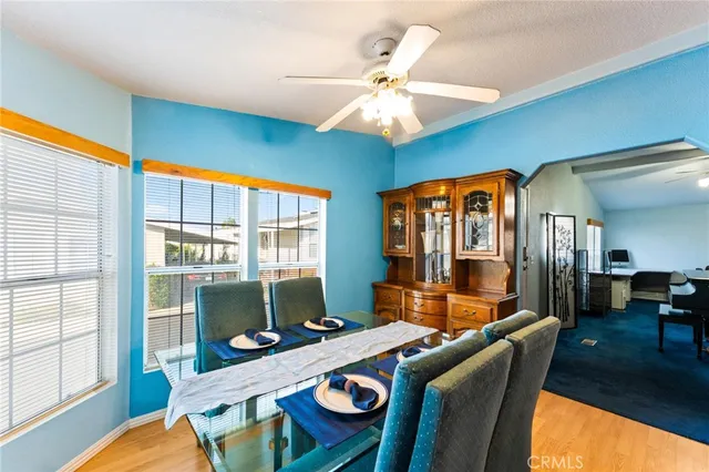 a dining room with furniture a chandelier and wooden floor