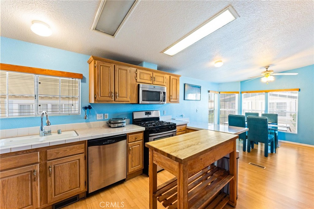 23301 Ridge Rte Drive, Unit 165 Laguna Hills, CA 92653 - Photo 10 of 31 a kitchen with a sink a counter top space and living room view