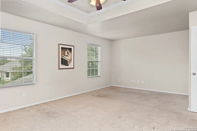 an empty room with windows and closet