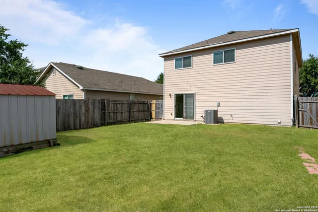 a view of a house with a backyard