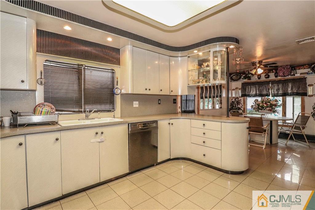 99 Ashley Road Edison, NJ 08817 - Photo 12 of 38 a kitchen with granite countertop white cabinets and white appliances