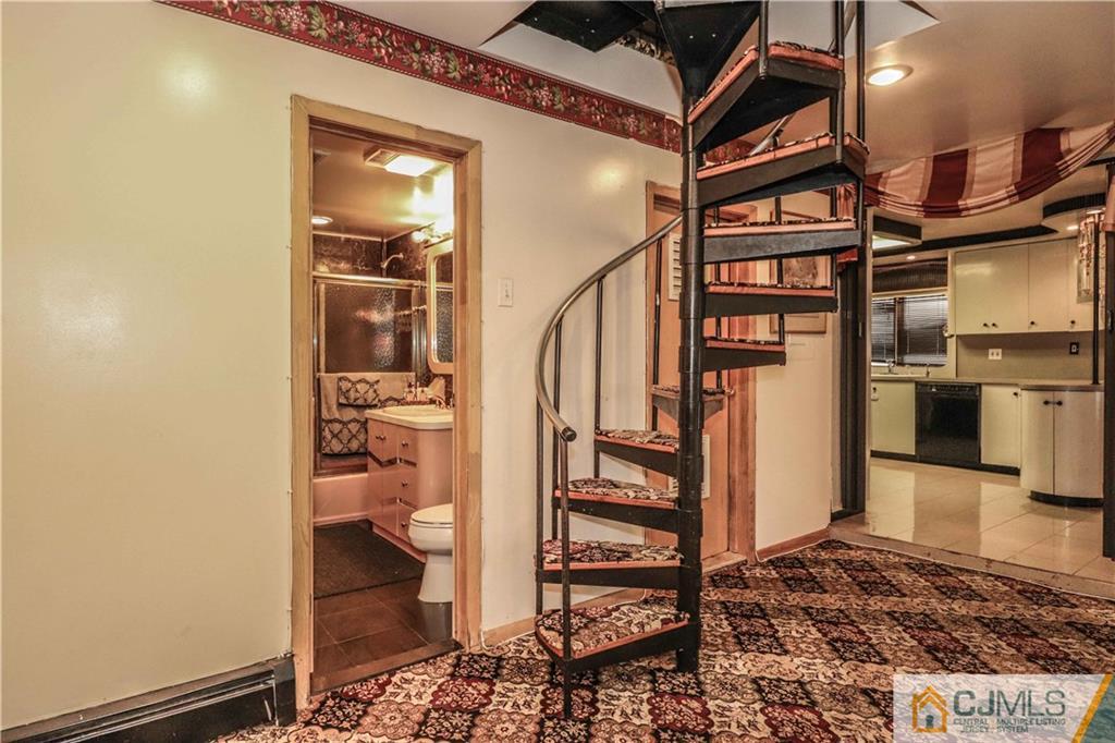 99 Ashley Road Edison, NJ 08817 - Photo 16 of 38 a view of a hallway with a dining table and chairs