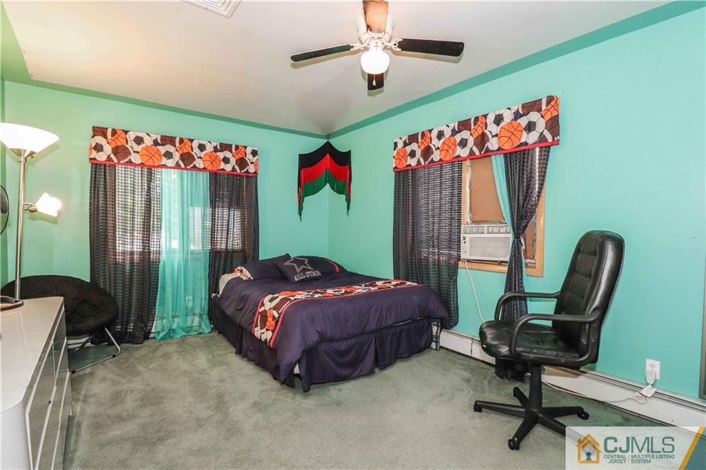99 Ashley Road Edison, NJ 08817 - Photo 27 of 38 a bedroom with a bed a desk and a chandelier