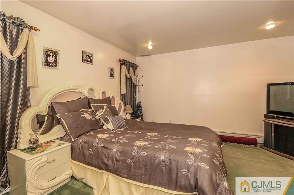 99 Ashley Road Edison, NJ 08817 - Photo 31 of 38 a bed room with a bed and a television