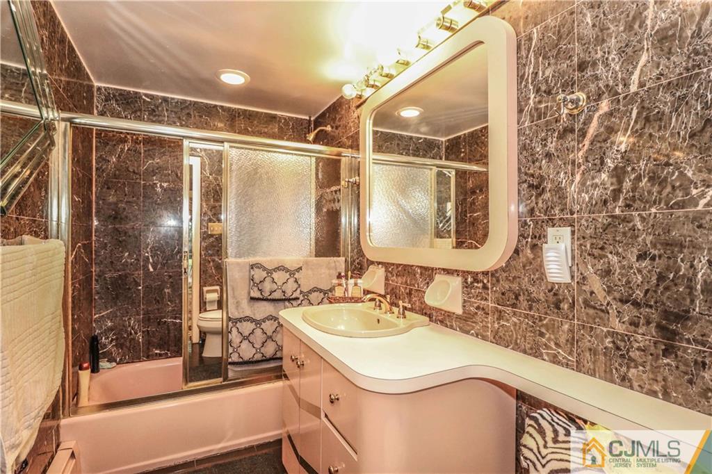 99 Ashley Road Edison, NJ 08817 - Photo 32 of 38 a bathroom with a sink and a mirror