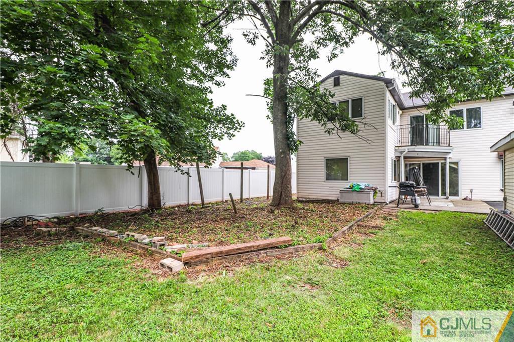 99 Ashley Road Edison, NJ 08817 - Photo 36 of 38 a view of a backyard with a tree