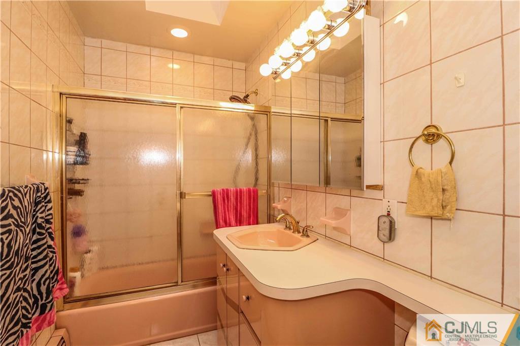 99 Ashley Road Edison, NJ 08817 - Photo 10 of 38 a bathroom with a sink and shower