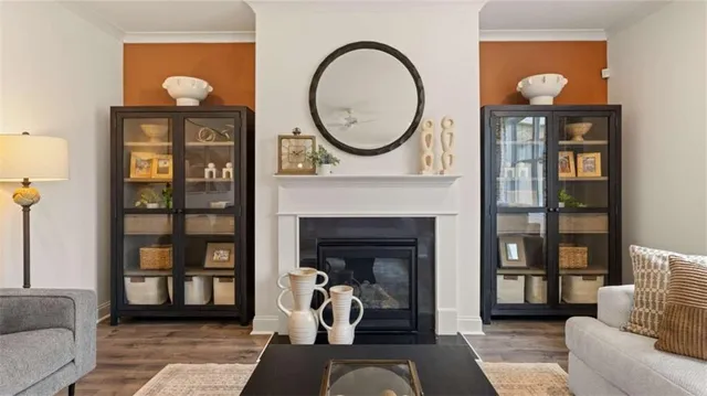 a living room with furniture a mirror and a lamp