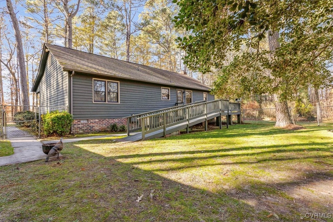 9531 Jerusalem Plank Road Waverly, VA 23890 - Photo 34 of 44 Rear view of house featuring a deck and a yard