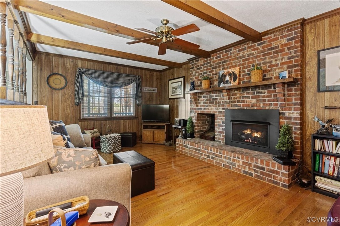 9531 Jerusalem Plank Road Waverly, VA 23890 - Photo 9 of 44 Living room featuring wooden walls, a brick firepl
