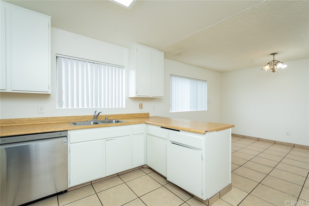 8865 Independence Avenue, Unit 26 Canoga Park, CA 91304 - Photo 12 of 40 a kitchen with a sink cabinets and window