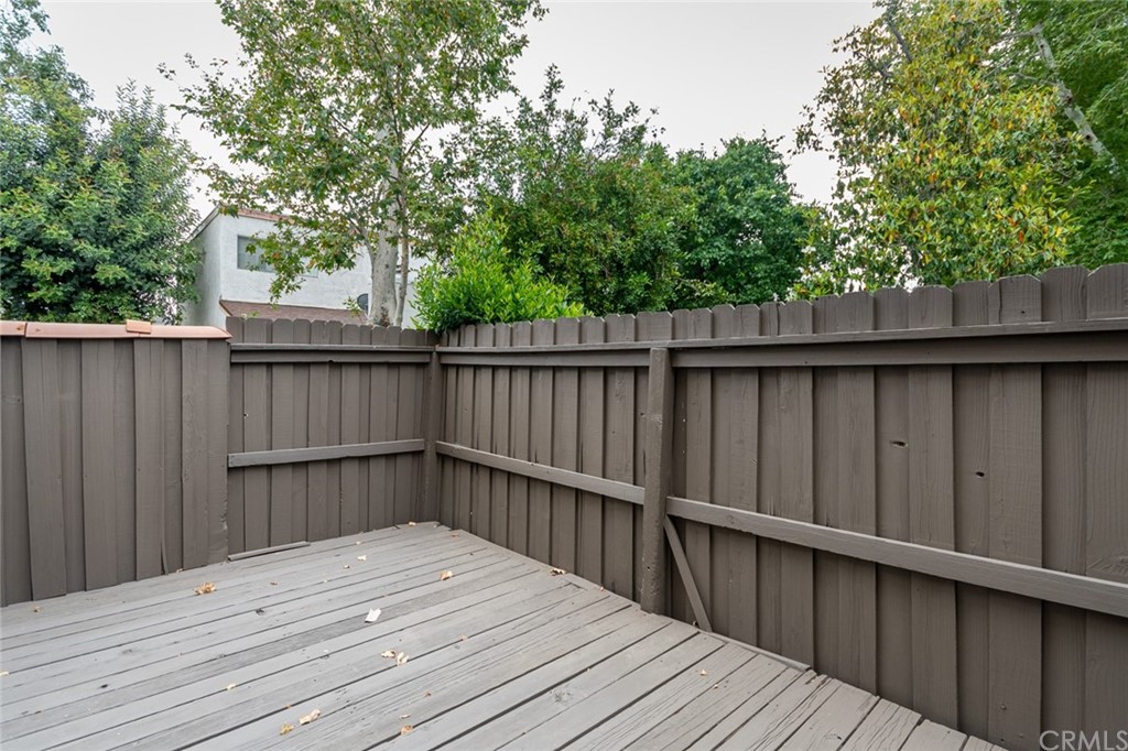 8865 Independence Avenue, Unit 26 Canoga Park, CA 91304 - Photo 30 of 40 a balcony with wooden floor and fence