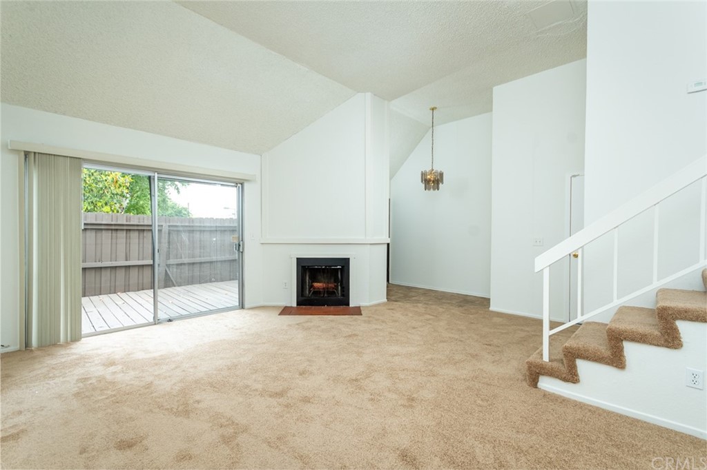 8865 Independence Avenue, Unit 26 Canoga Park, CA 91304 - Photo 3 of 40 a view of an empty room with a fireplace and a window