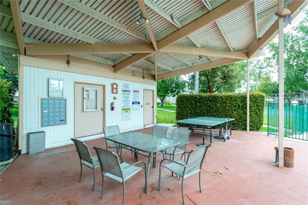 8865 Independence Avenue, Unit 26 Canoga Park, CA 91304 - Photo 40 of 40 a view of patio with table and chairs under an umbrella with a small yard