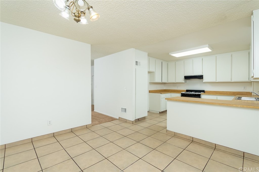8865 Independence Avenue, Unit 26 Canoga Park, CA 91304 - Photo 9 of 40 a kitchen with granite countertop white cabinets and stainless steel appliances