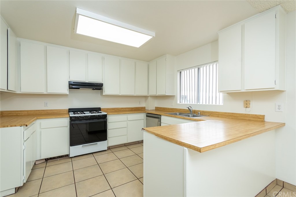 8865 Independence Avenue, Unit 26 Canoga Park, CA 91304 - Photo 10 of 40 a kitchen with a sink and a stove top oven